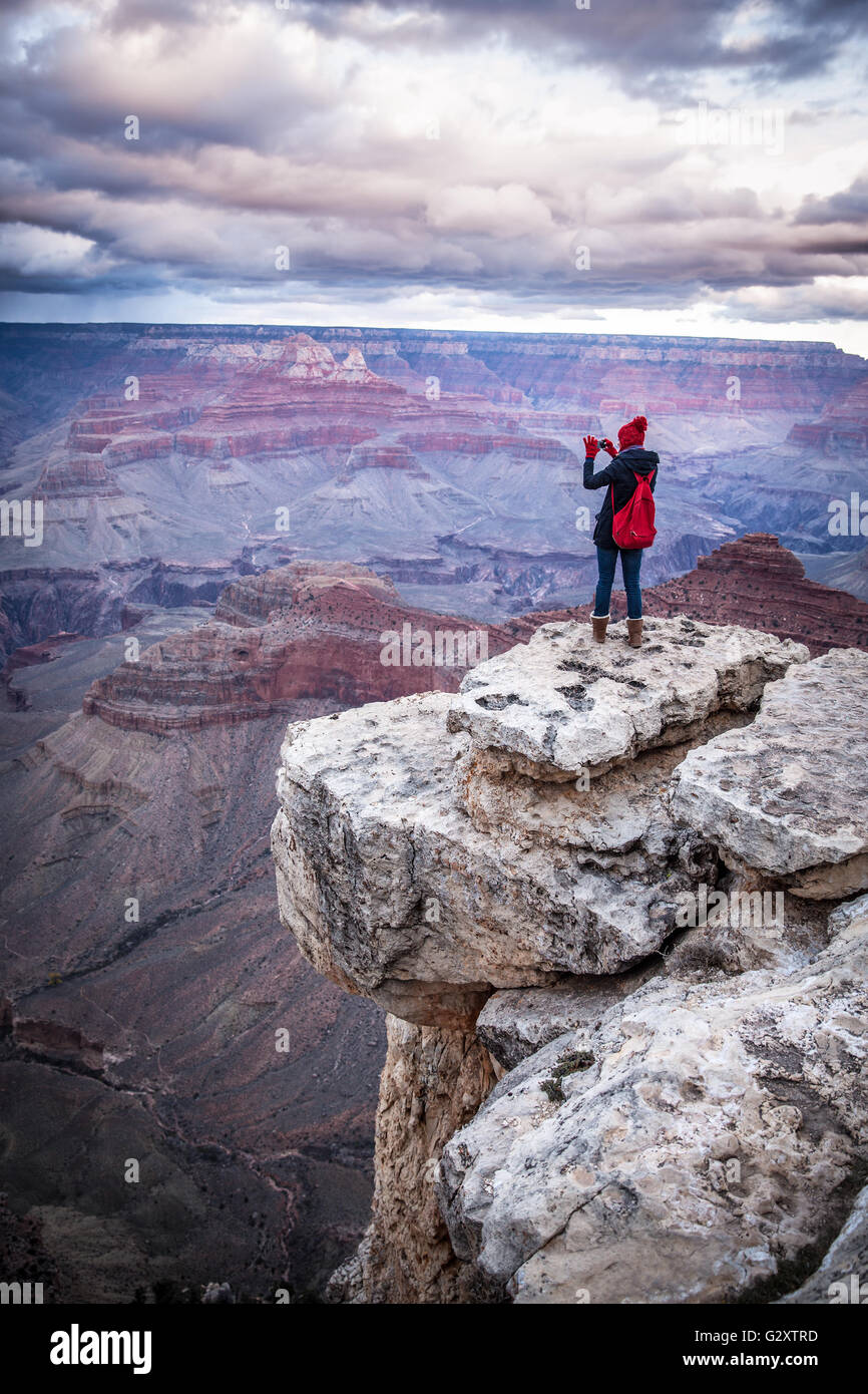 girl standing at the edge of a cliff in the Grand Canyon Stock Photo ...