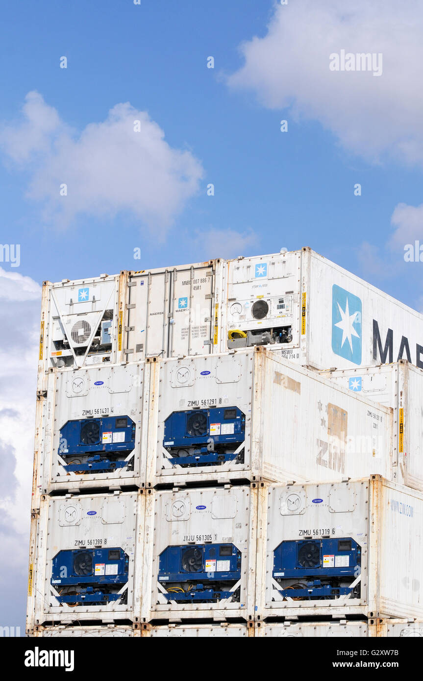 A stack of white shipping containers on blue sky background Stock Photo