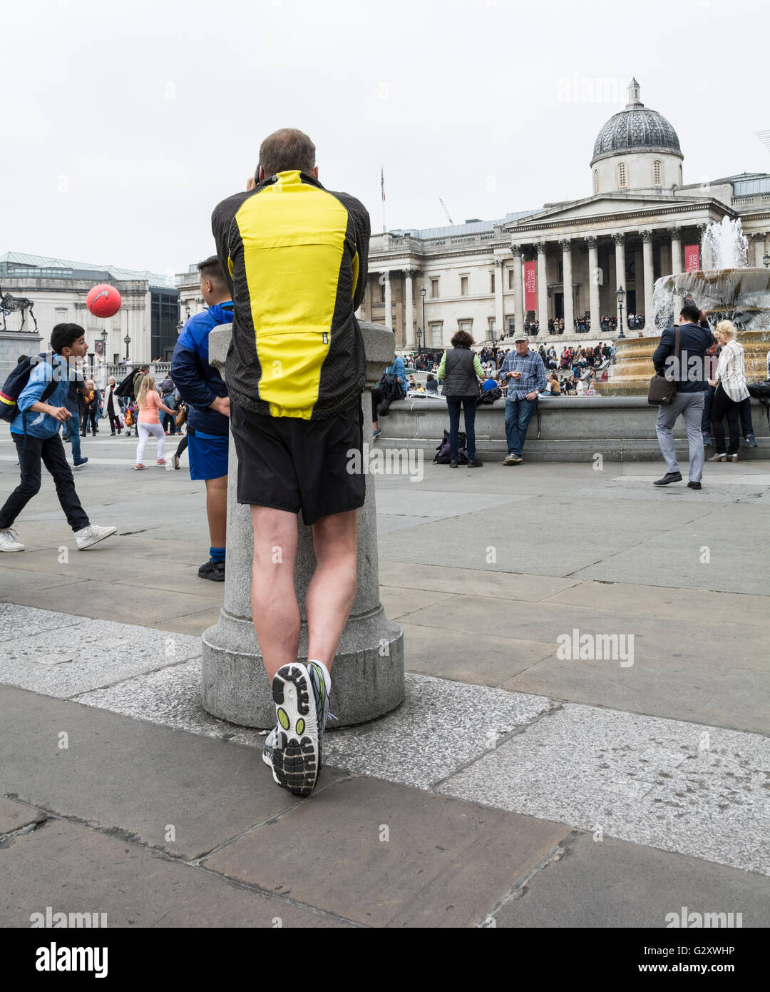 A male jogger in Trafalgar Square in London's West End, England, UK