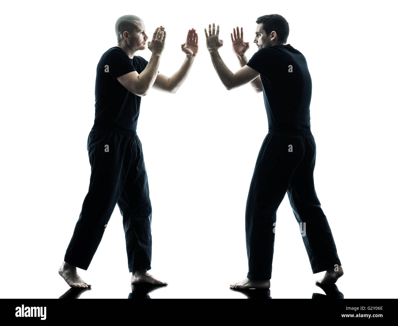 two caucasian men krav maga fighters fighting isolated silhouette on