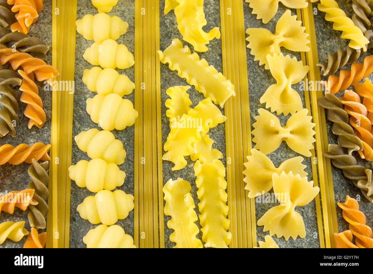 Pasta mix arranged on a stone table Stock Photo