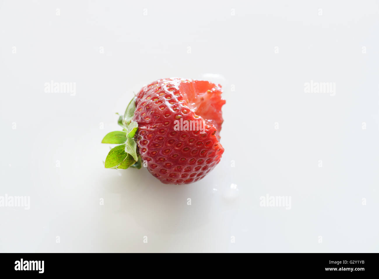 bite out of a fresh strawberry Stock Photo Alamy