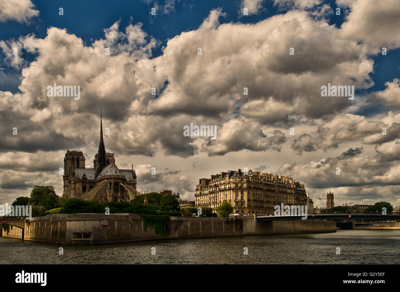 Cathedral Notre Dame and buildings by the Seine river Stock Photo