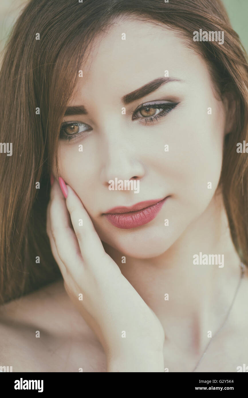 Beautiful young woman hand touching face outdoors Stock Photo - Alamy