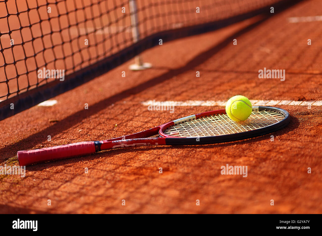 Tennis ball and racket on the court Stock Photo Alamy