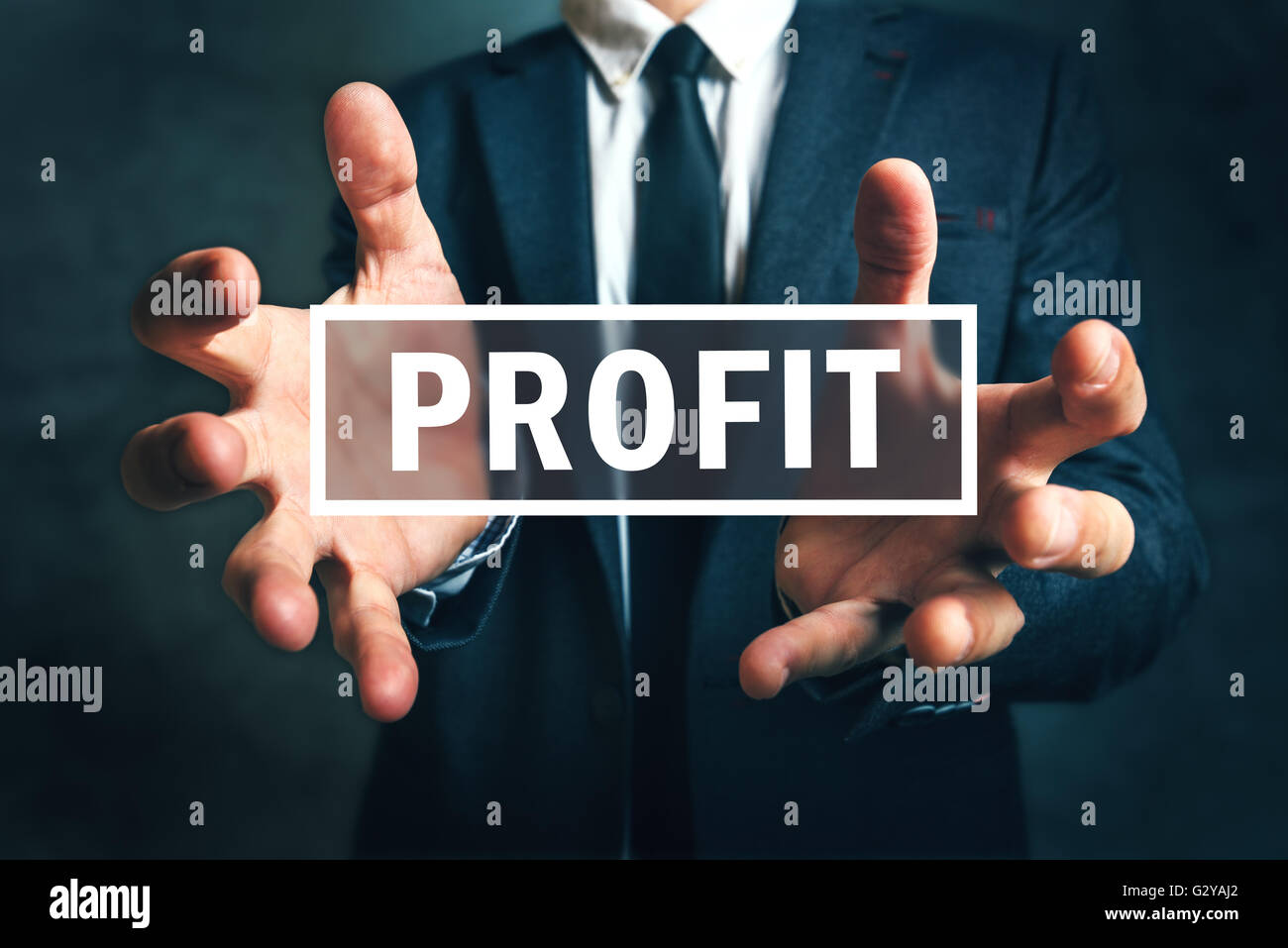 Concept of gaining business profit, businessman grabbing profit with his hands Stock Photo