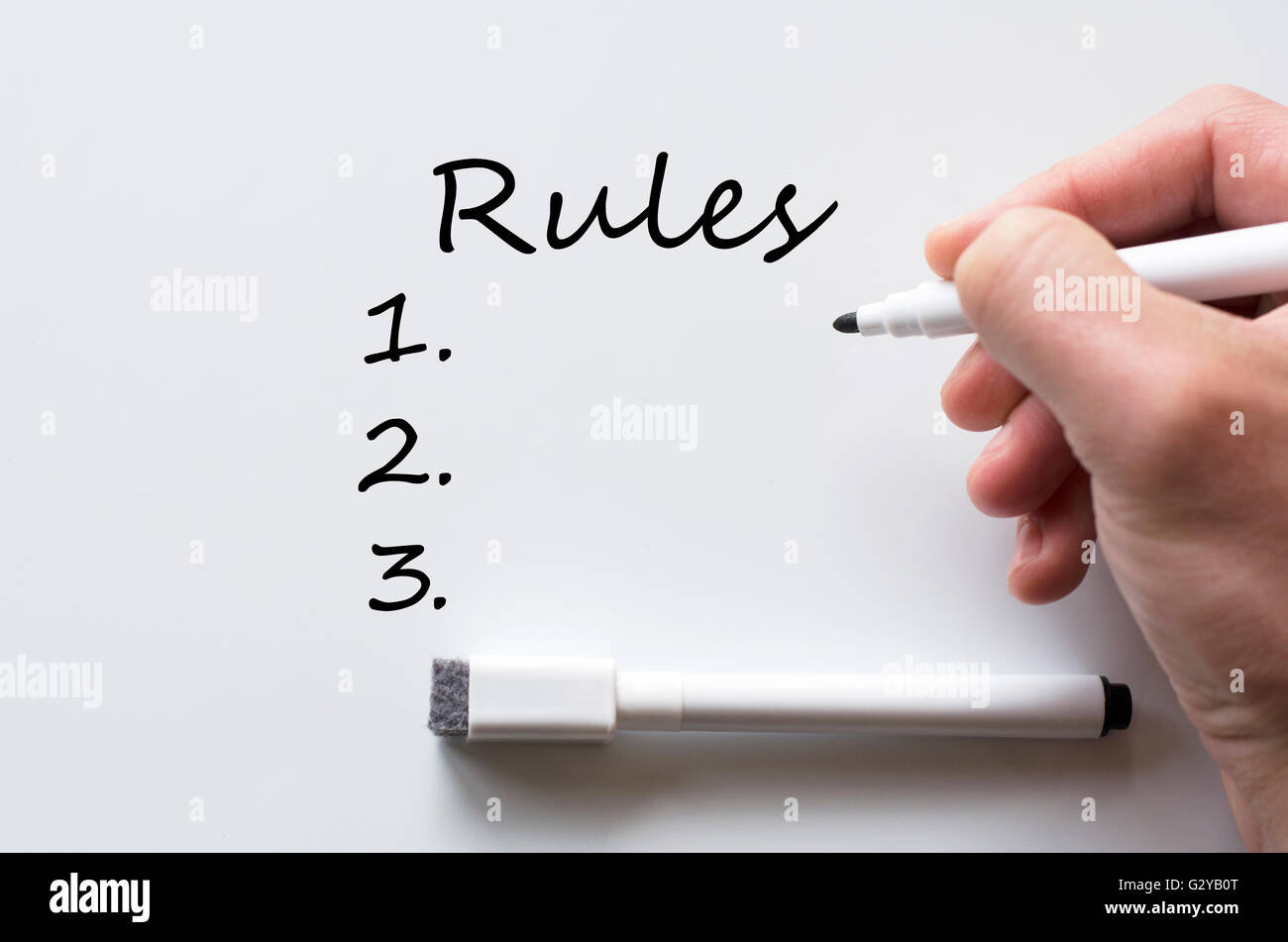 Human hand writing rules on whiteboard Stock Photo - Alamy