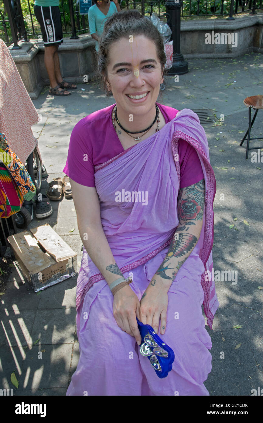 A Hare Krishna devotee with several tattoos in Union Square Park in Manhattan, New York City Stock Photo