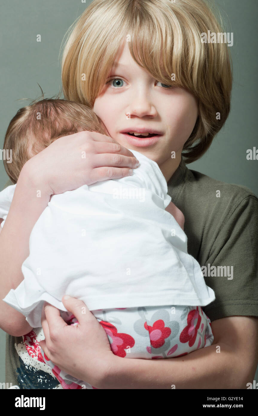 Boy holding infant brother hires stock photography and images Alamy