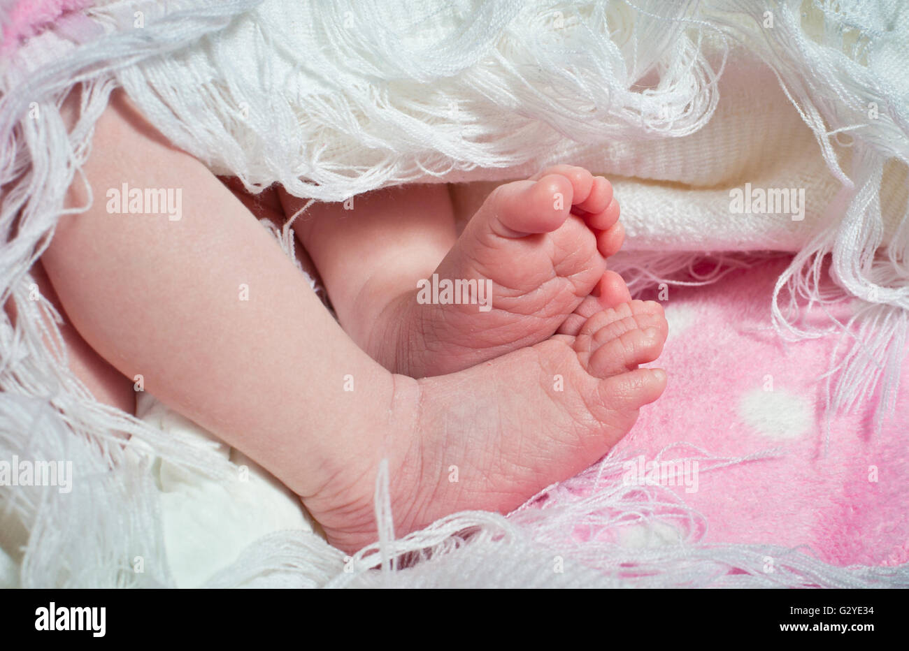 New born baby girls feet close up Stock Photo