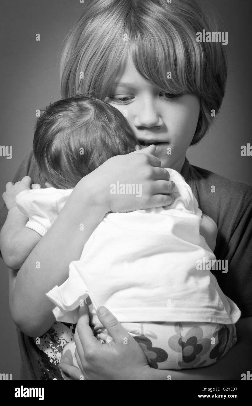 Little boy holding a newborn baby Stock Photo