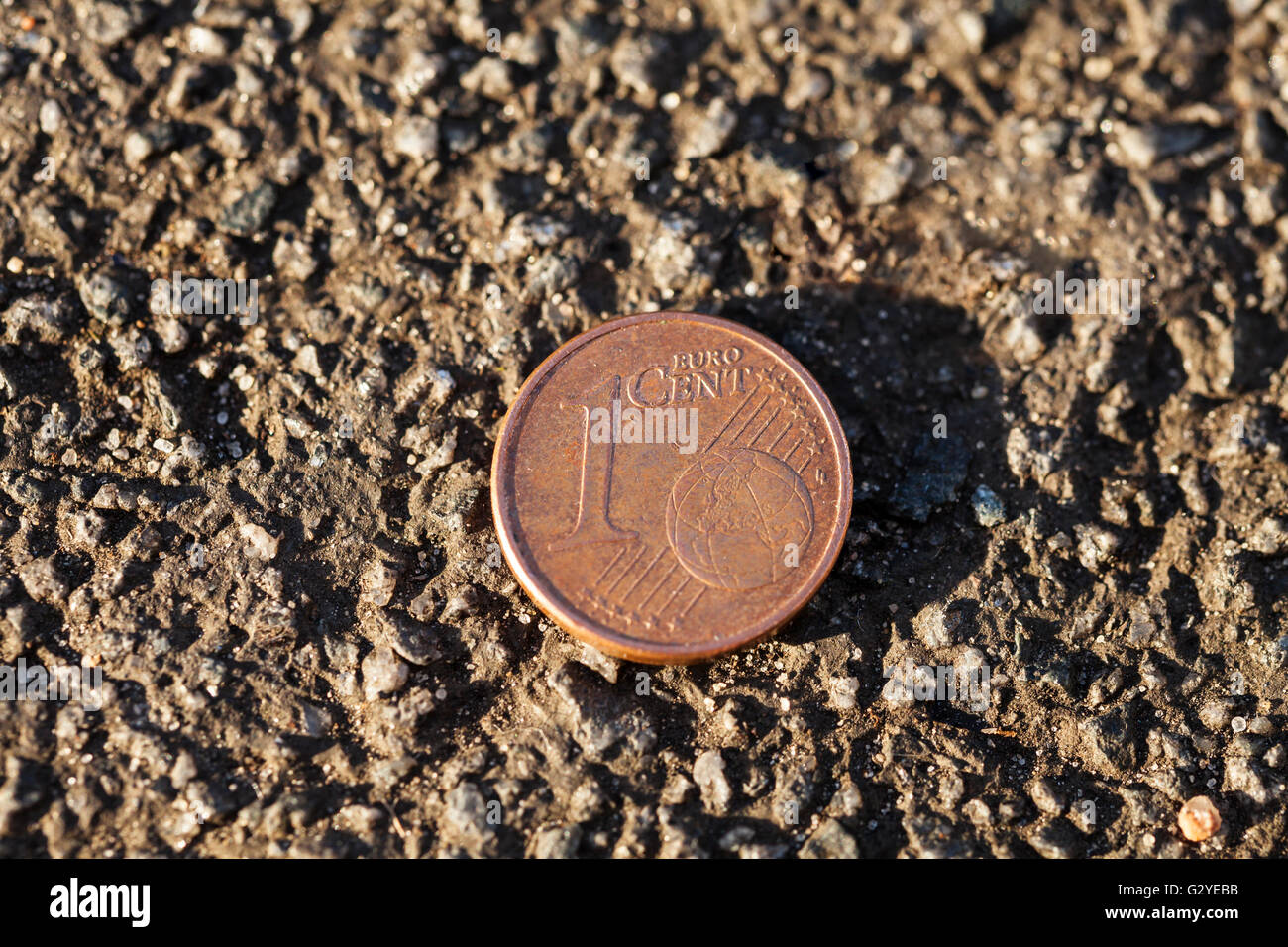 Luck penny on asphalt (Euro cent) Stock Photo