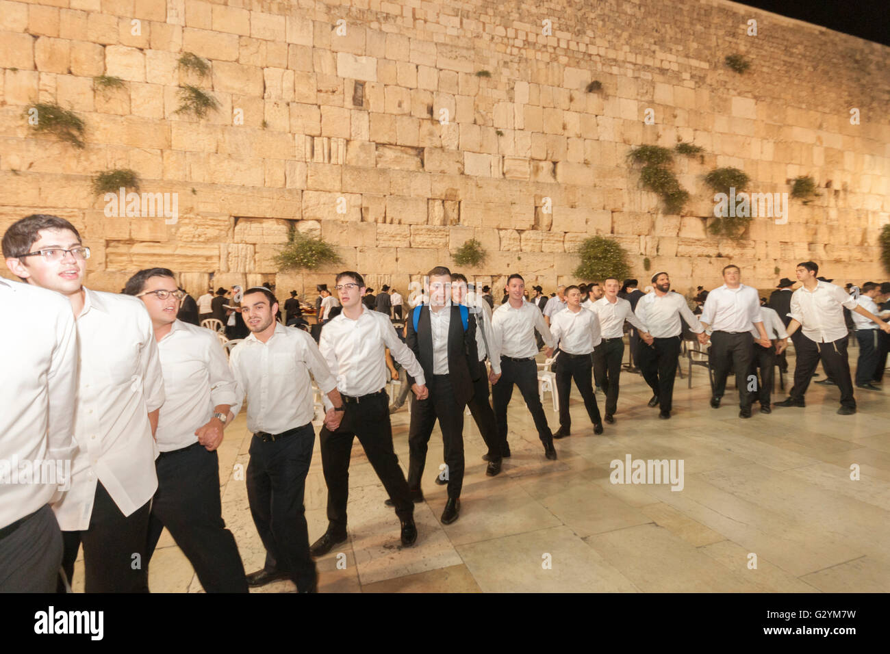 Jerusalem, Israel. 04th June, 2016. Jerusalem. A group of Yeshiva (Jewish High School) students dance with Israeli flags at the Western Wall, celebrating the 49th anniversary of the city's unification by Israeli soldiers in the Six-Day-War of 1967. Credit:  Yagil Henkin/Alamy Live News Stock Photo