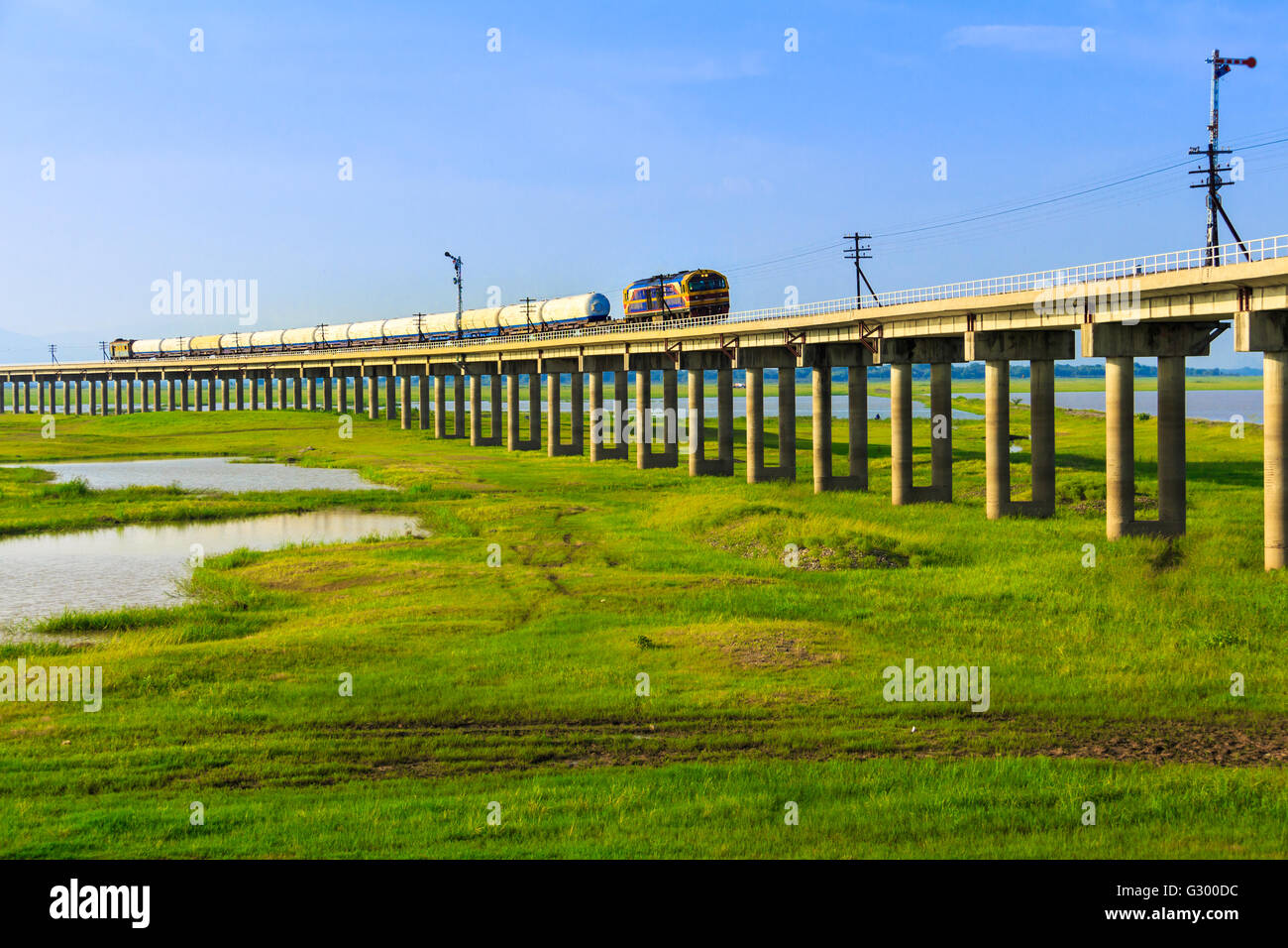 A train bridge at Pa Sak Jolasid Dam, Thailand in sunset time Stock Photo