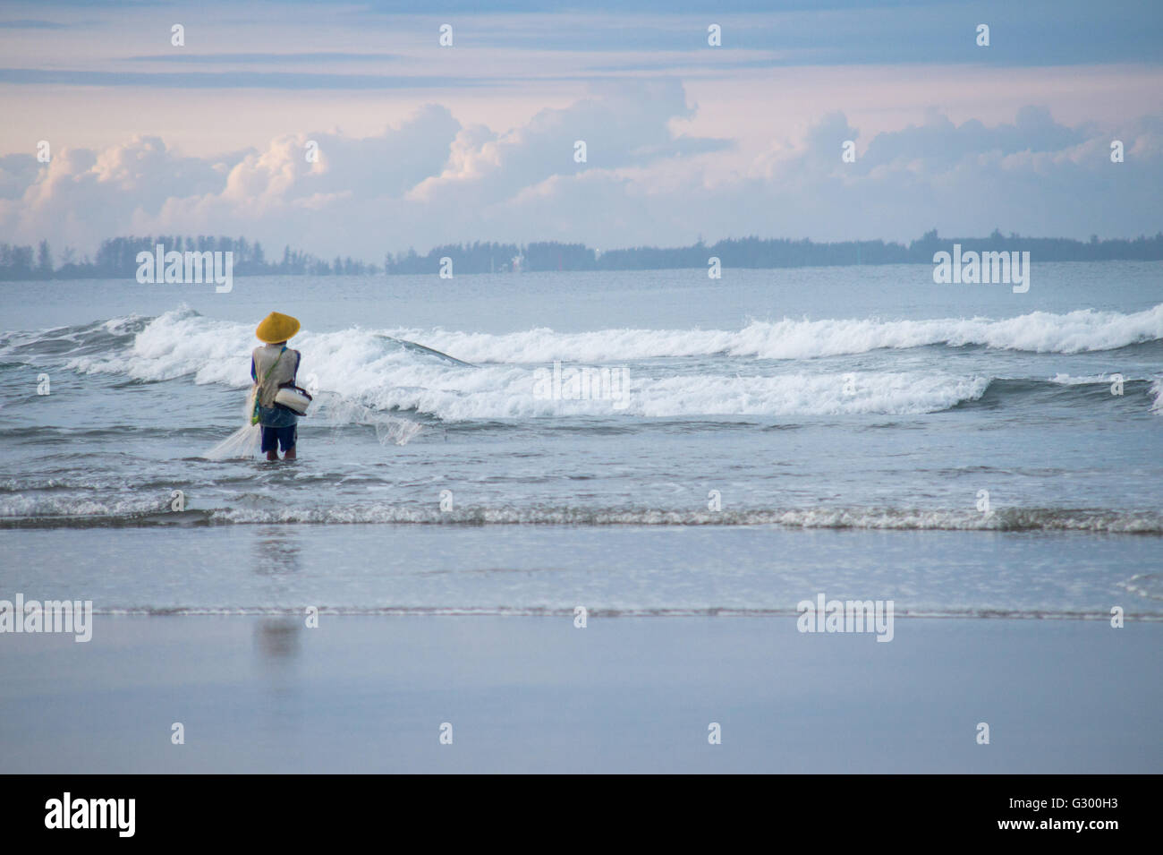 Fisherman on Seaside doing his job catching fish Stock Photo - Alamy