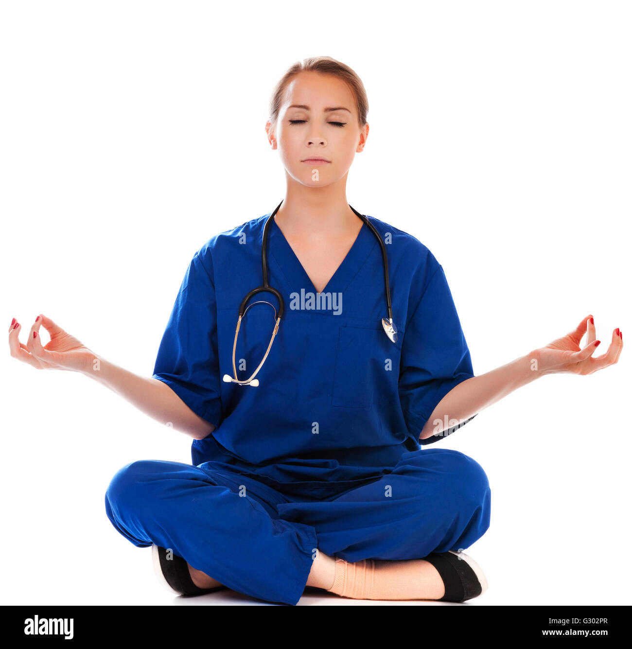 pretty nurse doing meditation isolated on white Stock Photo