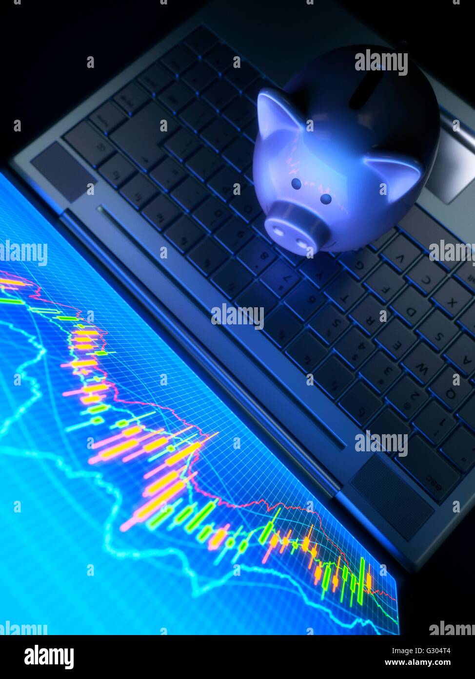 Piggy bank on a laptop computer with charts. Stock Photo