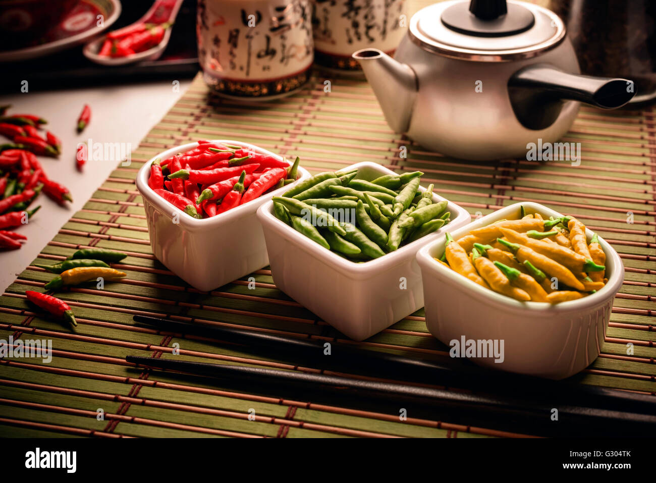 Red, green and yellow chilli peppers. Stock Photo