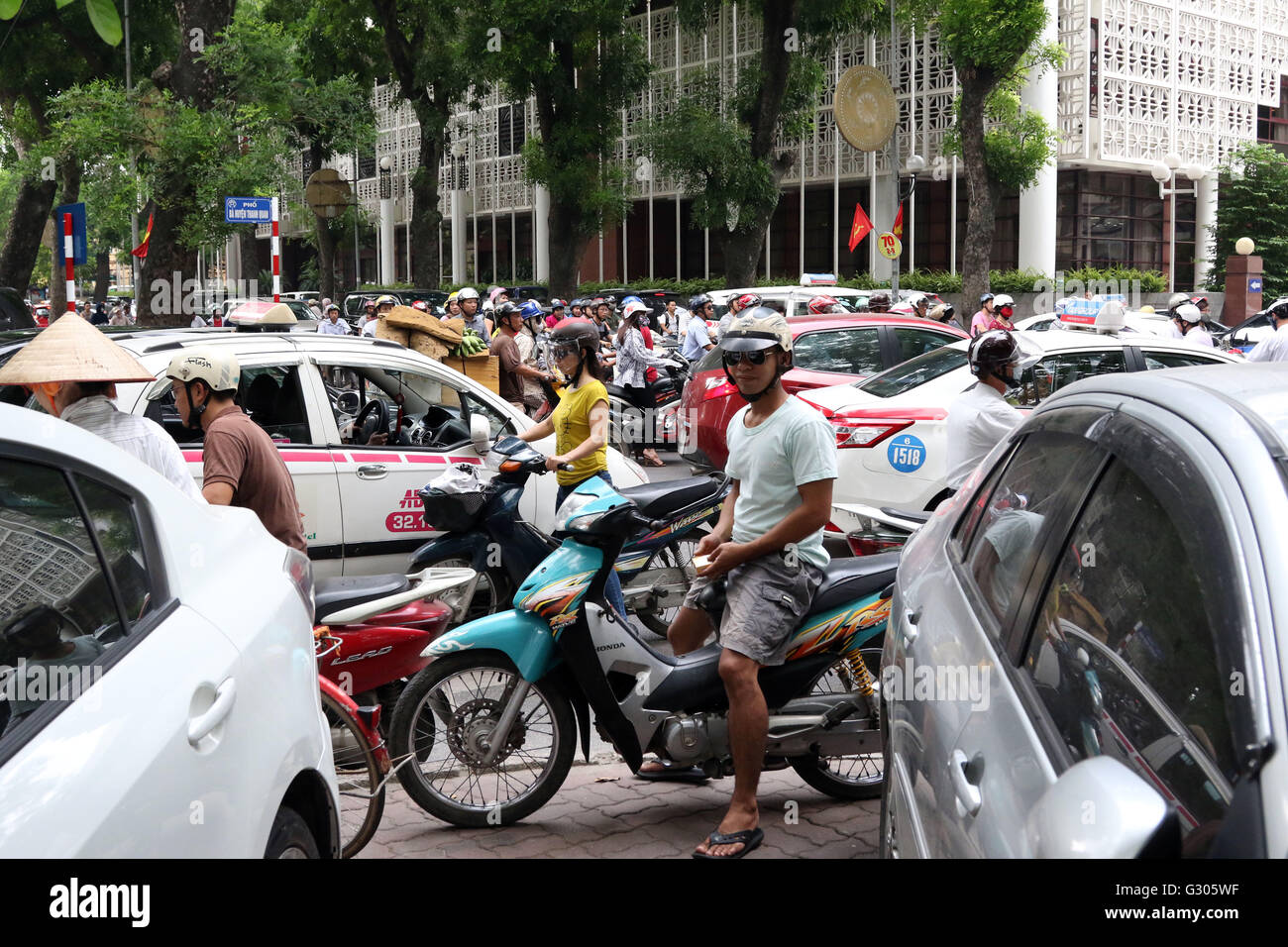 People riding scooters traffic jam Stock Photo - Alamy