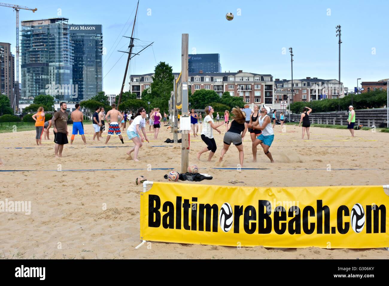 People enjoying a day at the Baltimore Inner harbor while playing beach