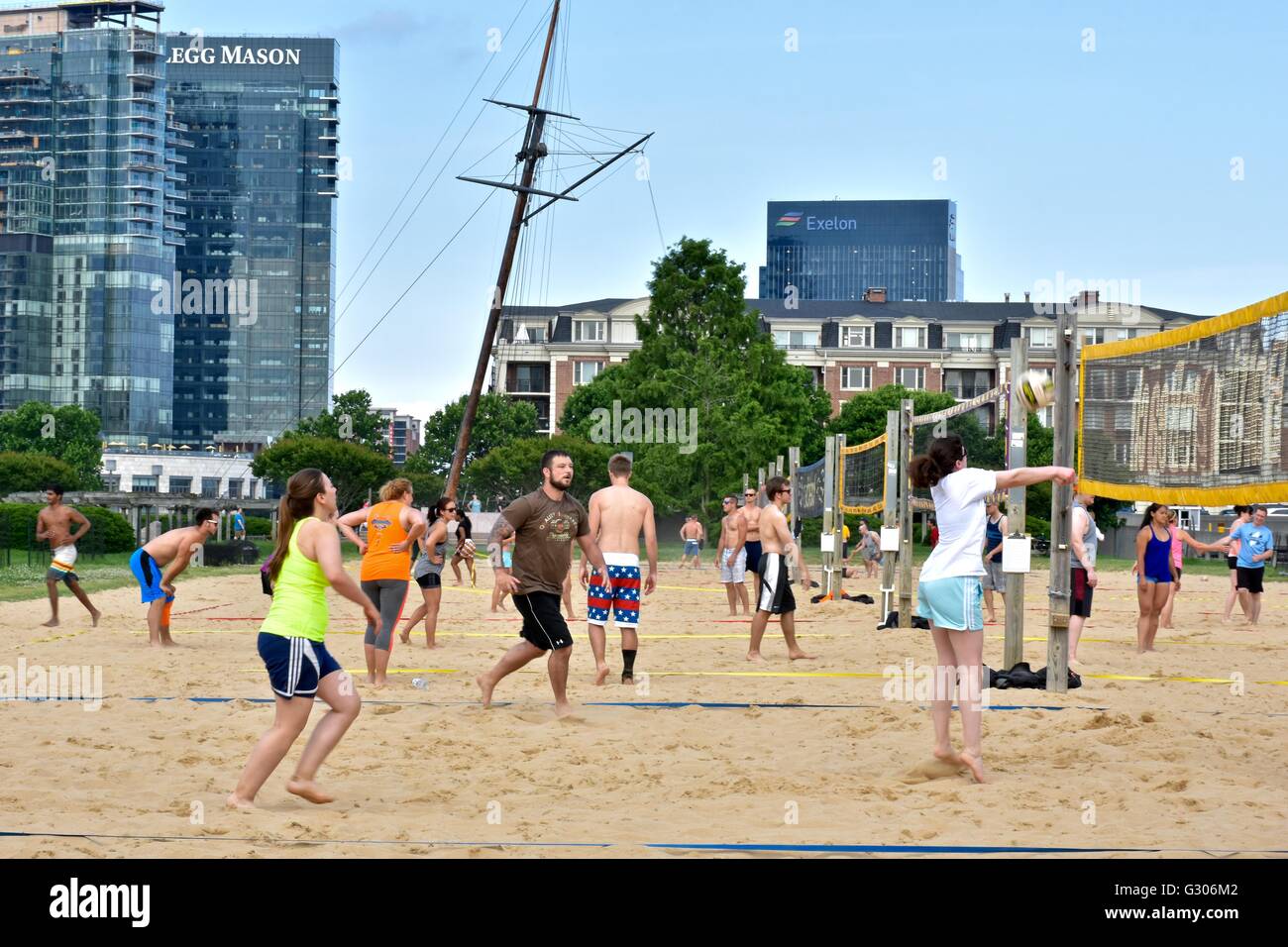 People enjoying a day at the Baltimore Inner harbor while playing beach