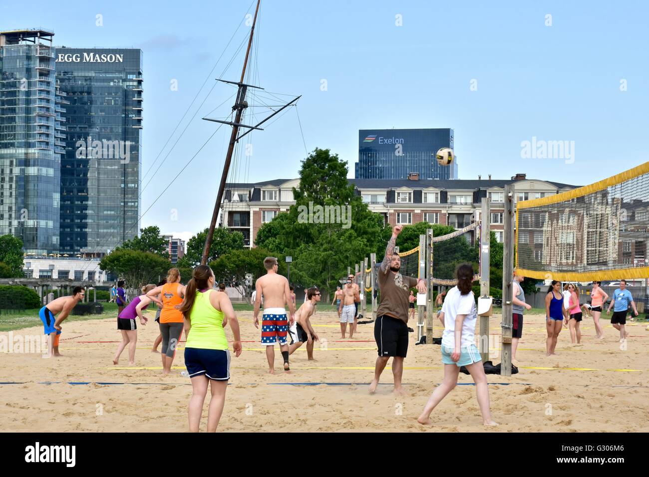 People enjoying a day at the Baltimore Inner harbor while playing beach
