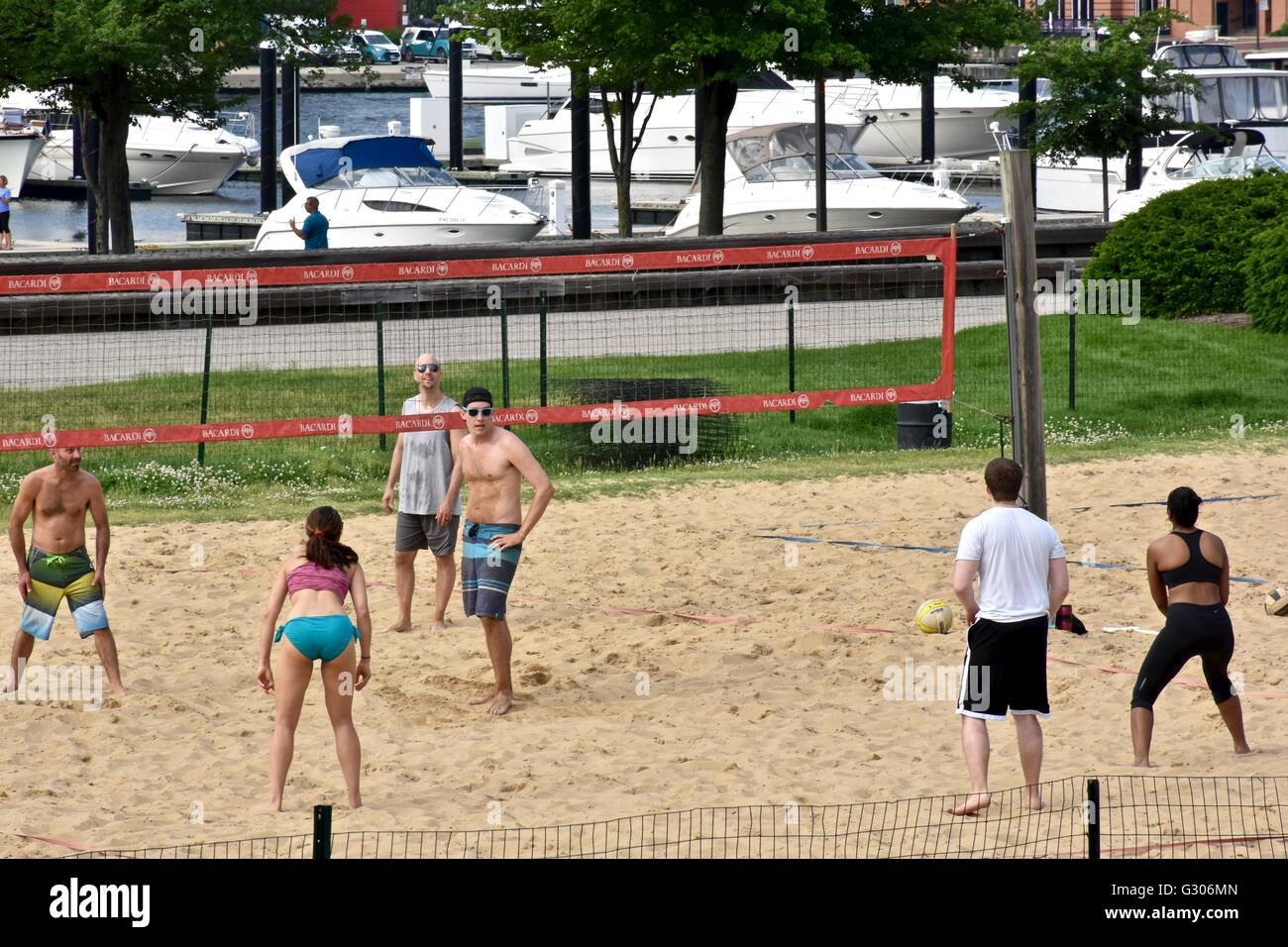 People enjoying a day at the Baltimore Inner harbor while playing beach