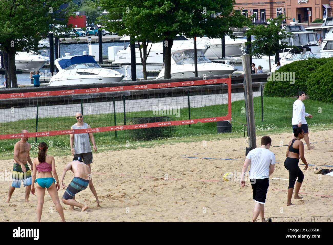 People enjoying a day at the Baltimore Inner harbor while playing beach