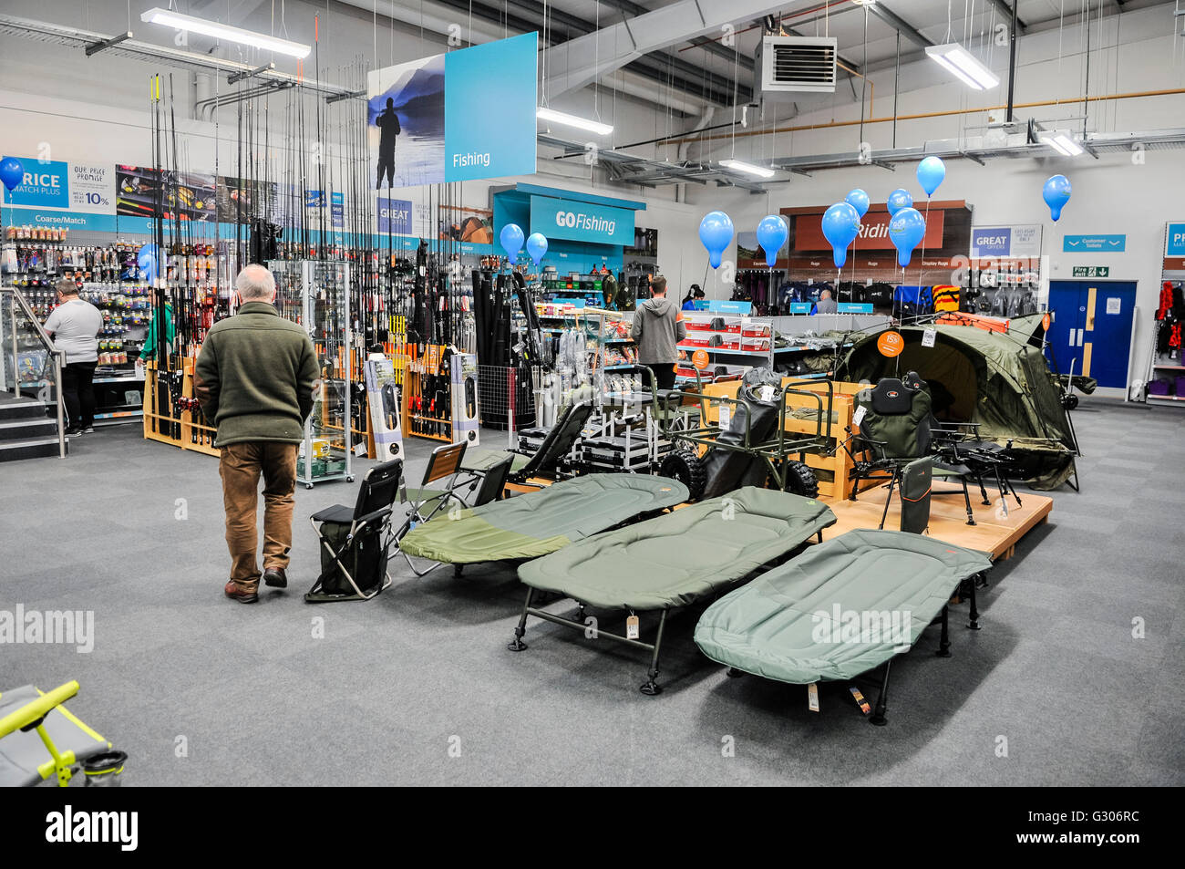 Customers look at equipment on sale in the fishing section of Go Outdoors sports shop Stock Photo Alamy