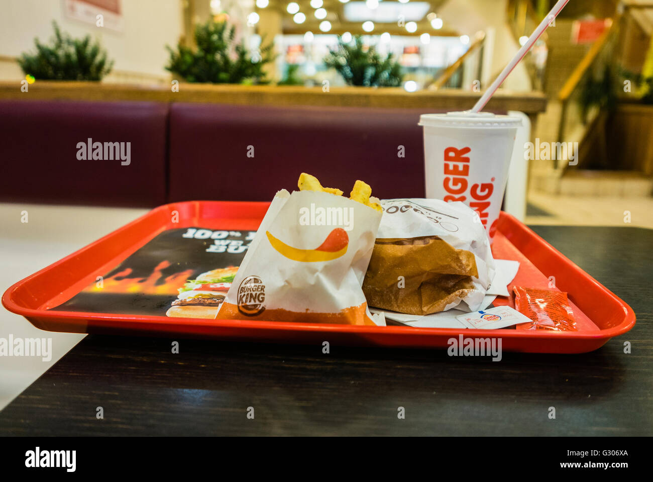 Hamburger, fries and drink on a tray in a Burger King fastfood
