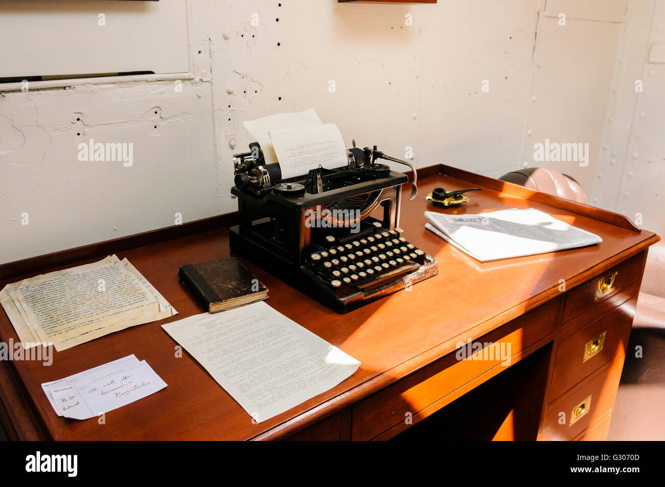 Old office desk and typewriter on board a ship from WW!. Stock Photo