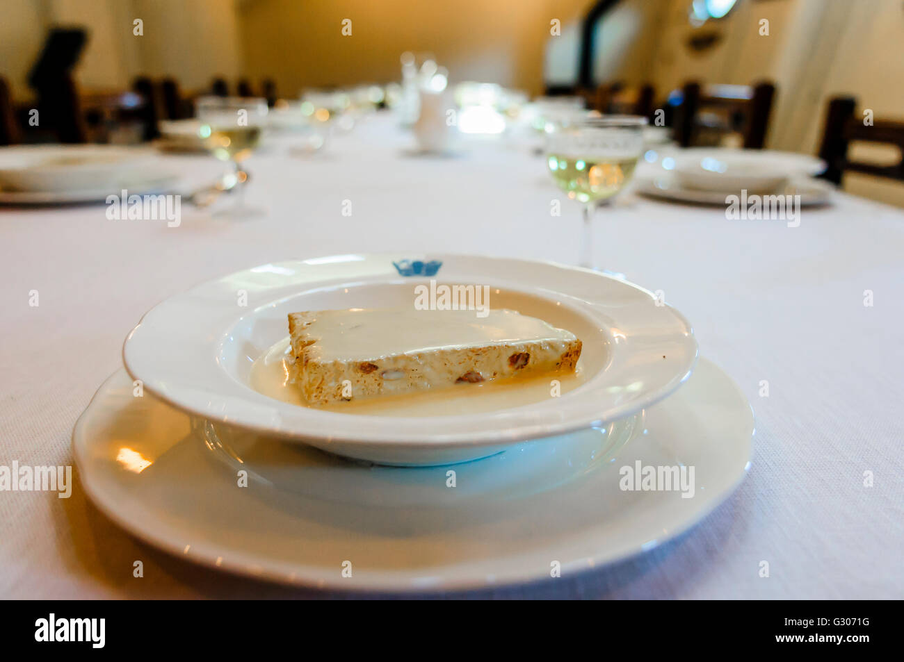 Sponge and custard on a formal dining table Stock Photo