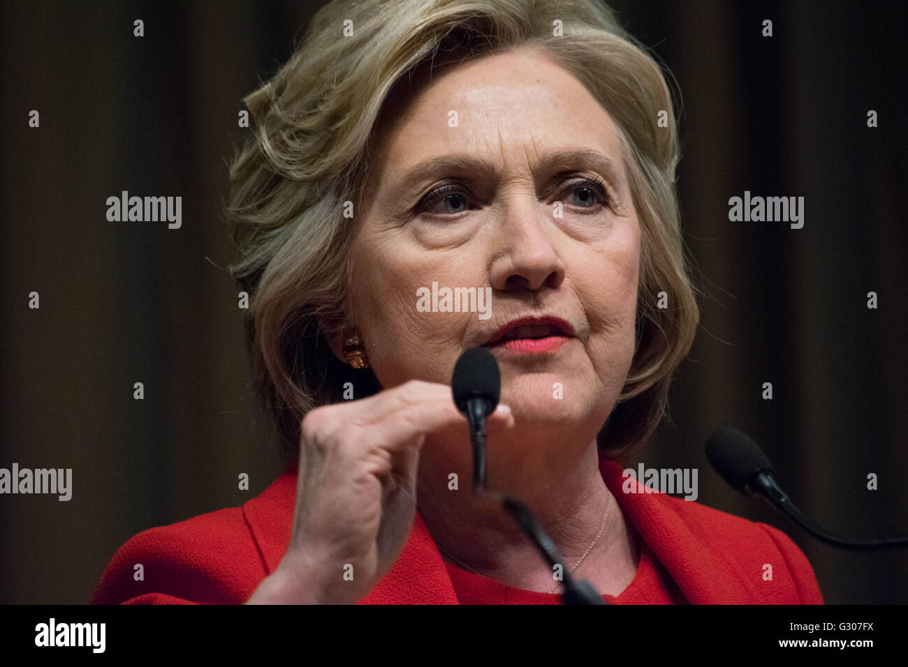 Hillary Clinton dressed in a red suit speaks at the 25th annual National Action Network convention. Stock Photo