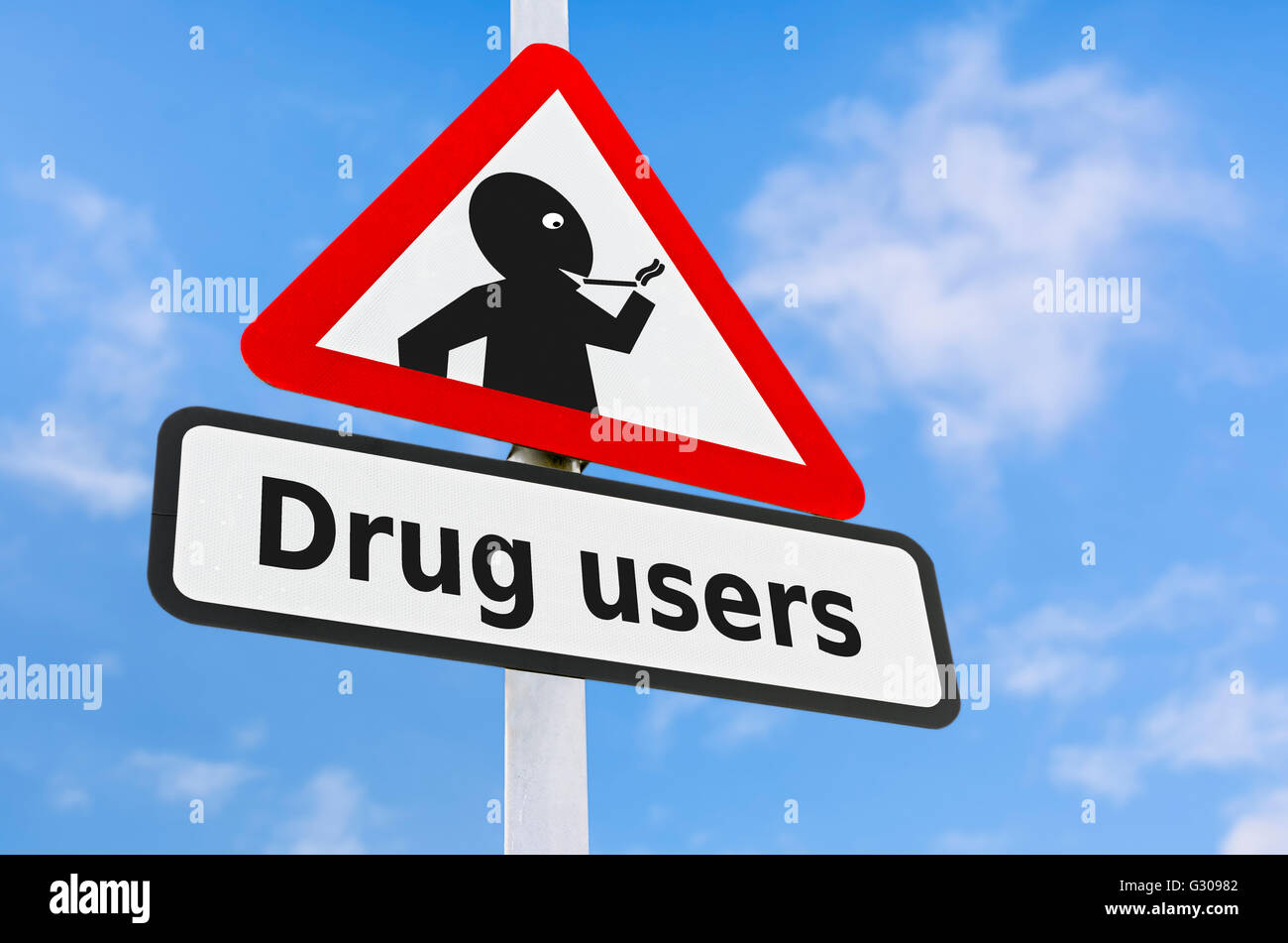 Drug users triangular warning sign against blue sky. Stock Photo