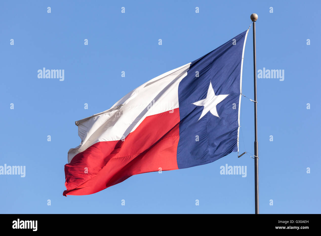 Flag of Texas against blue sky Stock Photo