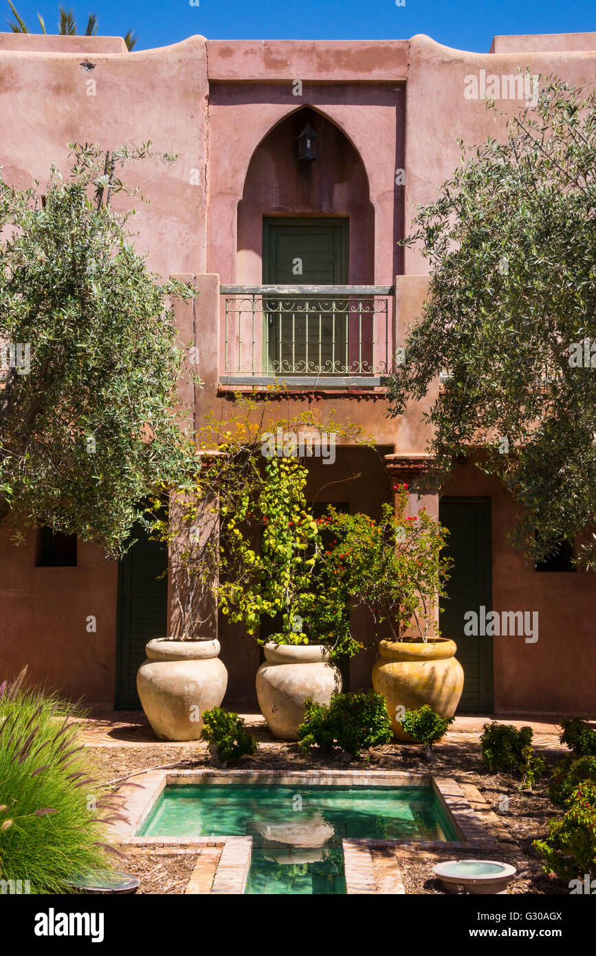 Typical Moroccan architecture, riad adobe walls, fountain and flower pots, Morocco, North Africa, Africa Stock Photo