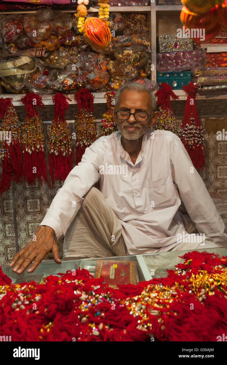 Man in shop selling traditional decorative items in Jaipur, Rajasthan