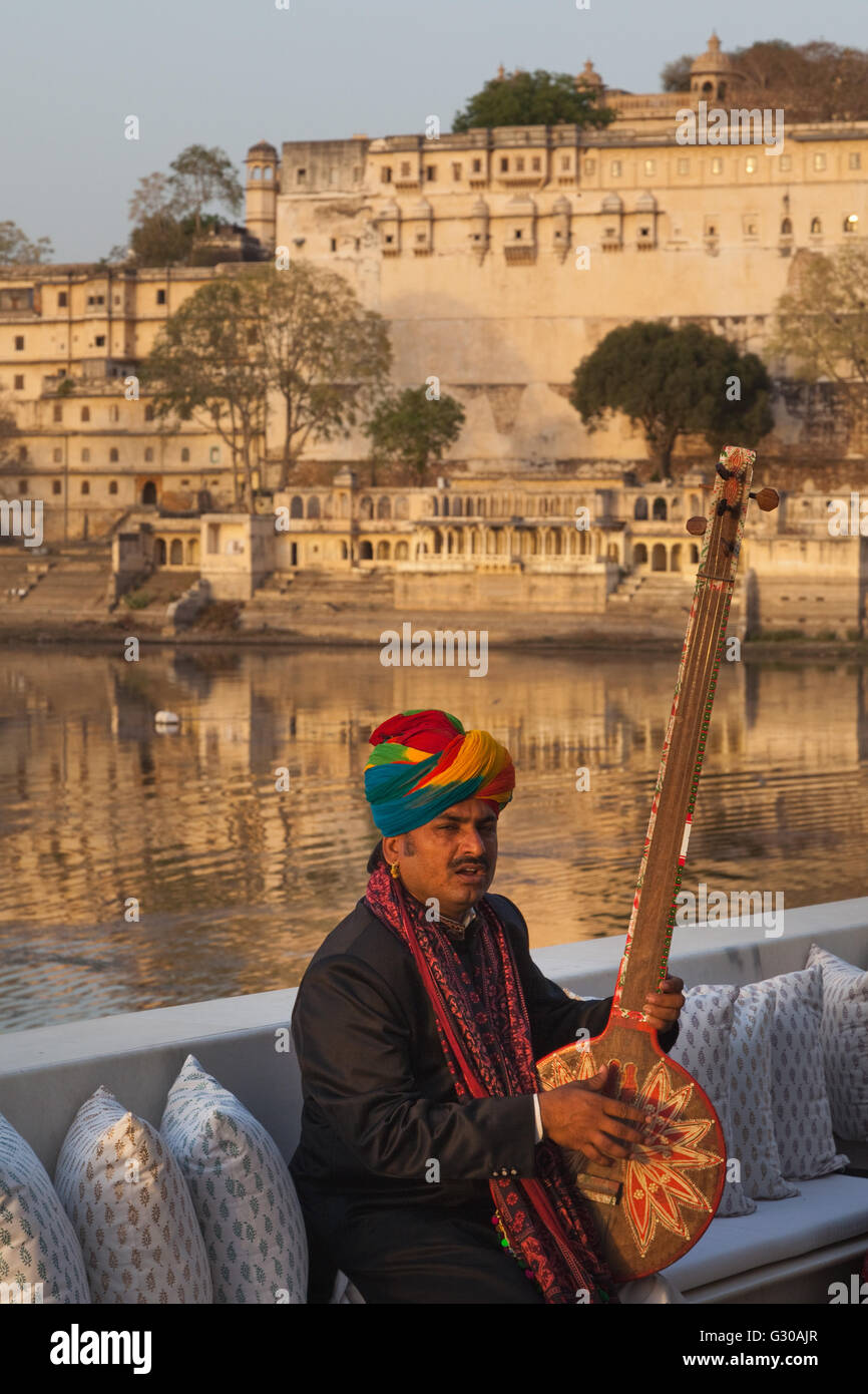 Man playing a traditional Tambura at Lake Palace Hotel in Udaipur
