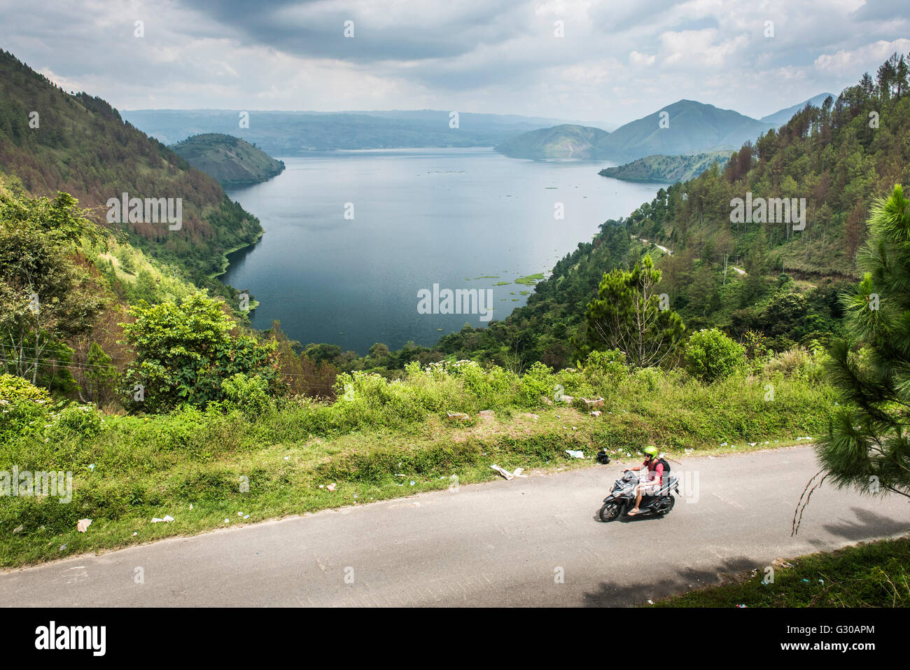 Tourist exploring Lake Toba (Danau Toba) by motorcycle, North Sumatra, Indonesia, Southeast Asia, Asia Stock Photo