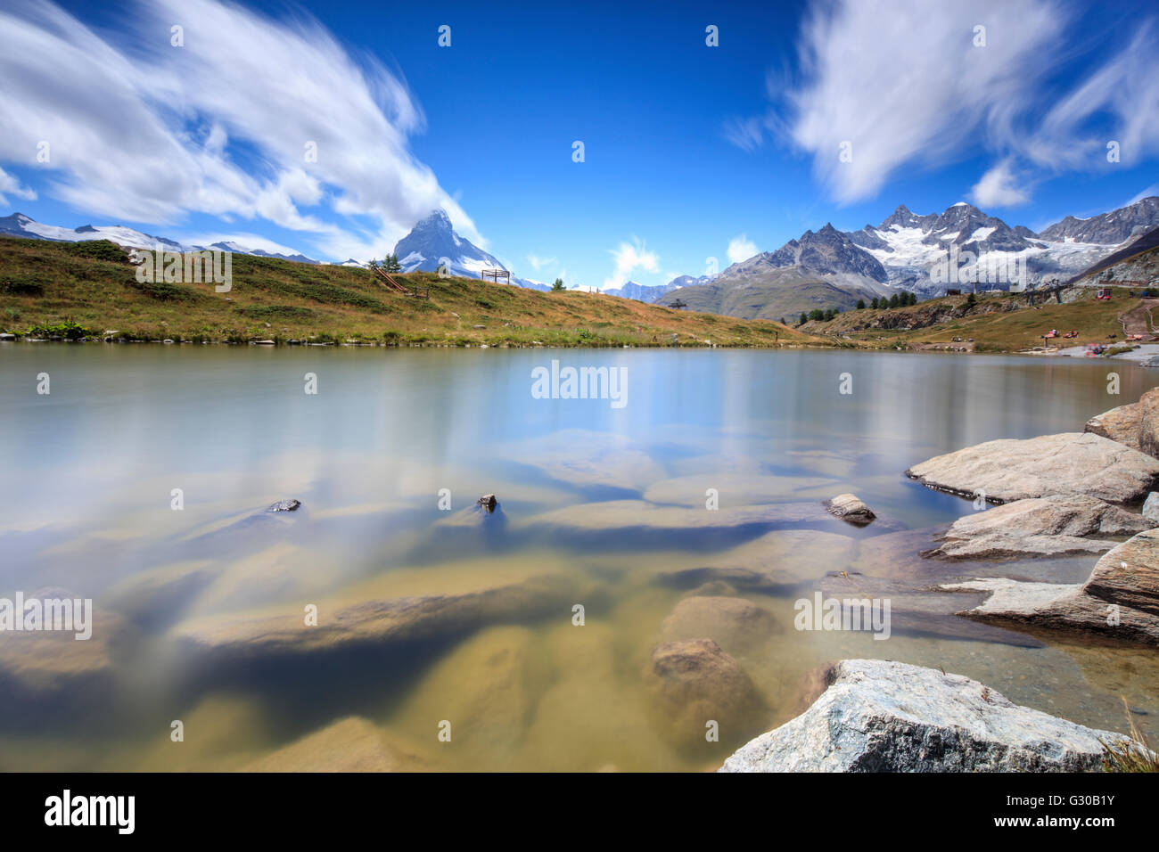 Lake Leisee frames the Matterhorn and the high peaks in the background in summer, Zermatt, Canton of Valais, Swiss Alps Stock Photo