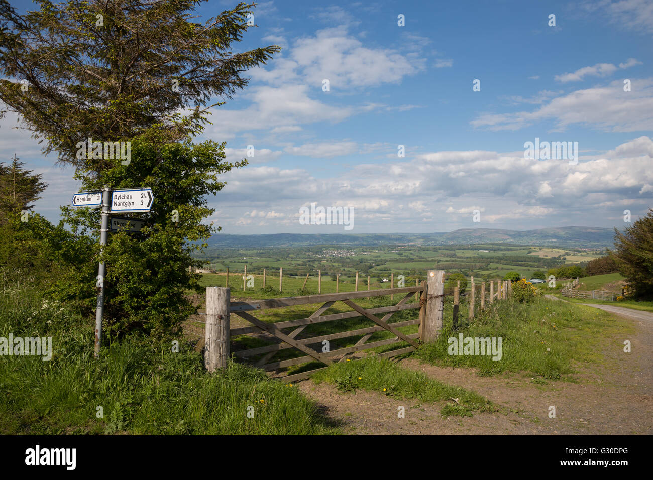 Signpost on a remote rural lane, for Bylchau, Nantglyn, Henllan, with the Vale of Clwyd in the distance Stock Photo