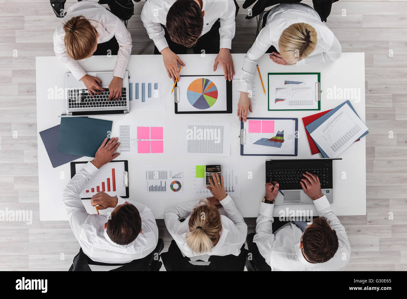 Business people discussing the charts and graphs showing the results of ...