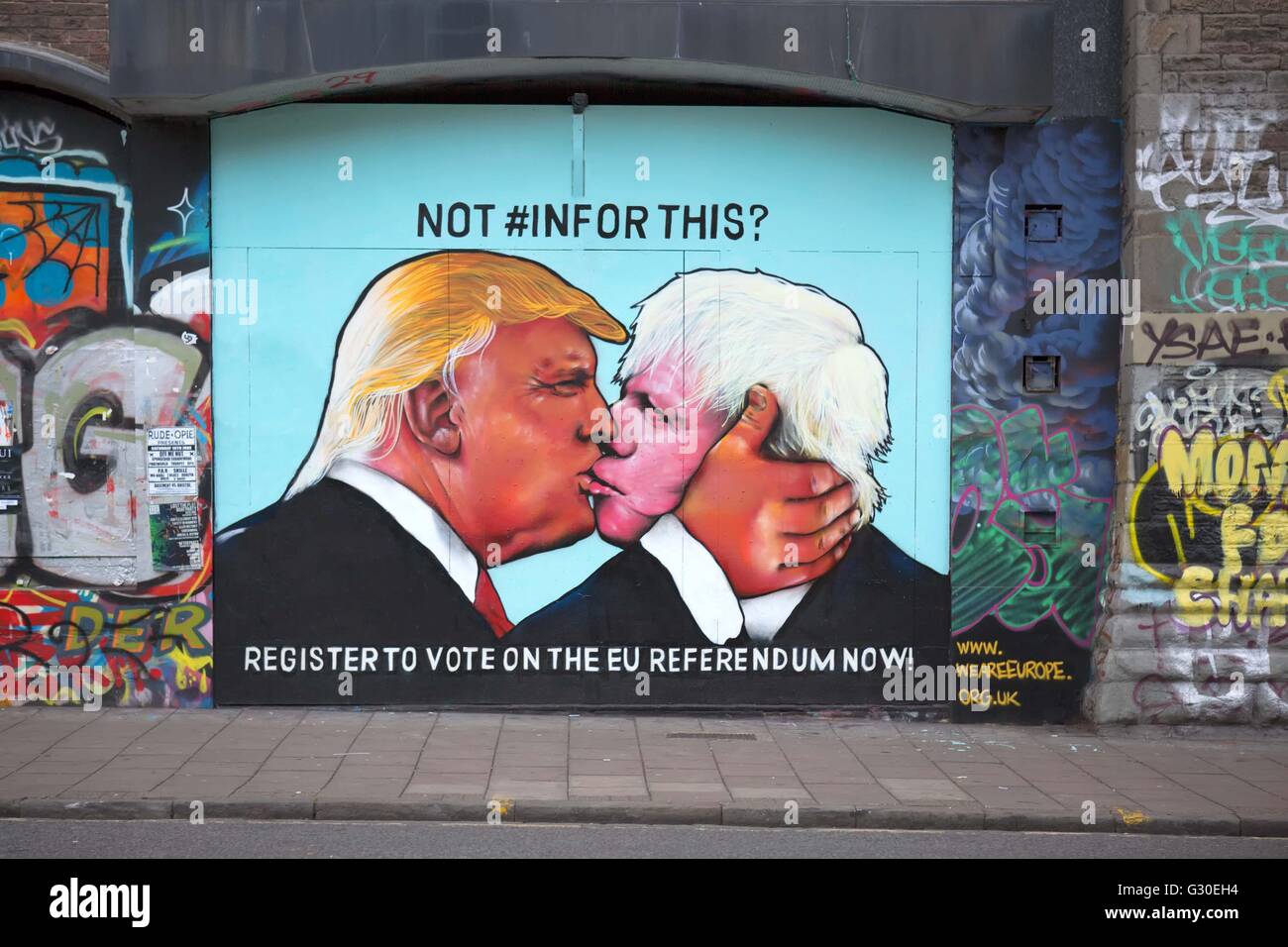 Street art in Bristol showing Donald Trump kissing Boris Johnson, to encourage people to vote in the 2016 EU referendum. Stock Photo