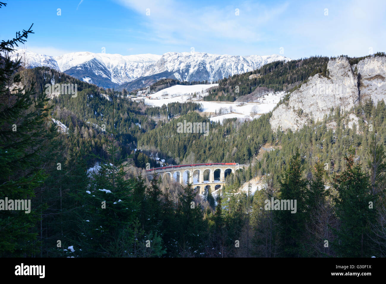 Semmering Railway with the Kalte Rinne viaduct with train Railjet ÖBB , right Polleroswand , in the background the Rax ( mountai Stock Photo