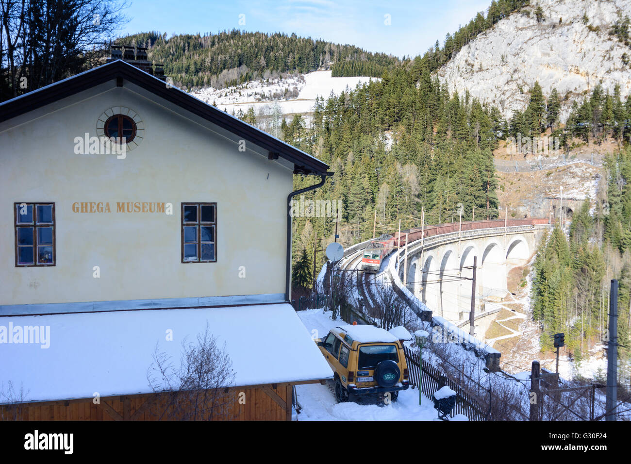 Semmering Railway with the Kalte Rinne viaduct with freight train of ÖBB at Ghega Museum , right Polleroswand, Austria, Niederös Stock Photo