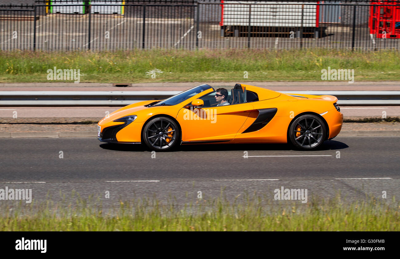 A luxurious McLaren MP4-12C Spider convertible sports car travelling along the Kingsway West Dual Carriageway in Dundee, UK Stock Photo