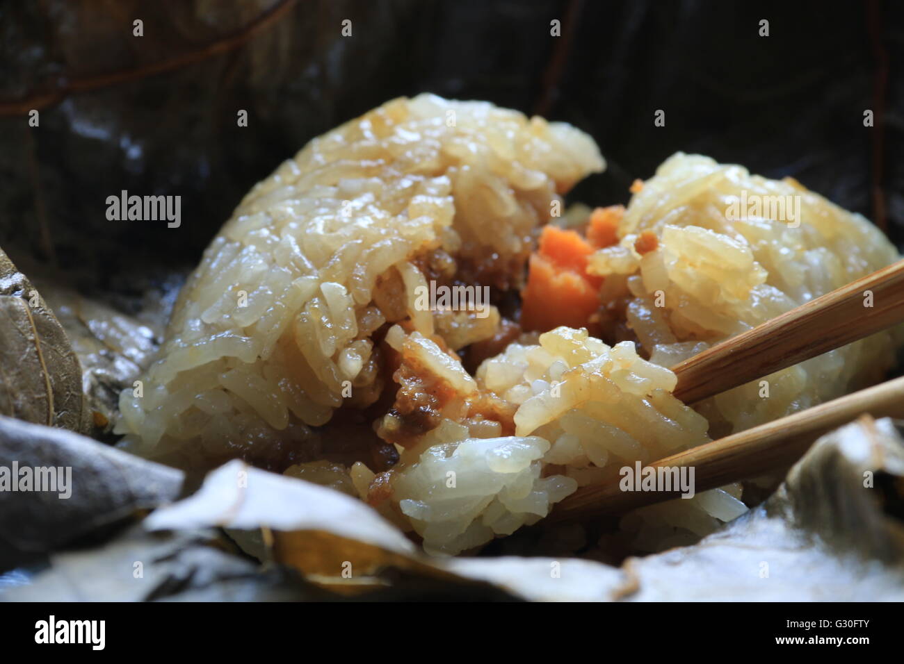 Lo Mai Gai. Steamed parcel of sticky rice with pork, shrimp, and egg in lotus leaf. Close-up view. Stock Photo