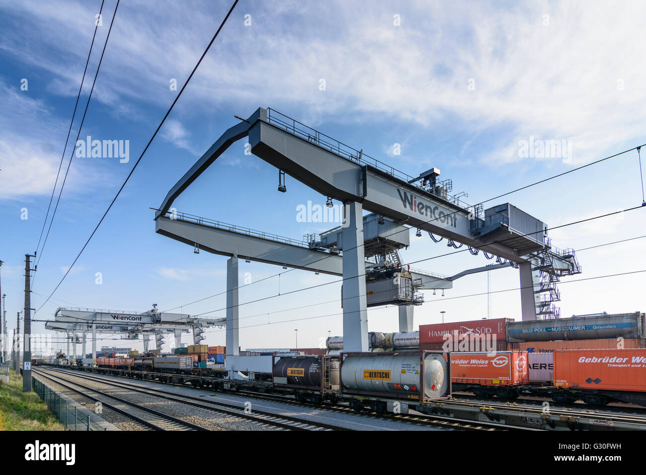Container Terminal Vienna Freudenau of Wiencont Container Terminal Company with crane runway and container train with containers Stock Photo