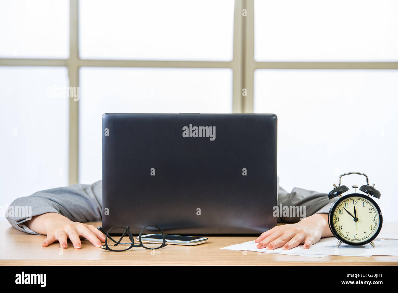 Tired woman are sleeping at desk in the office Stock Photo
