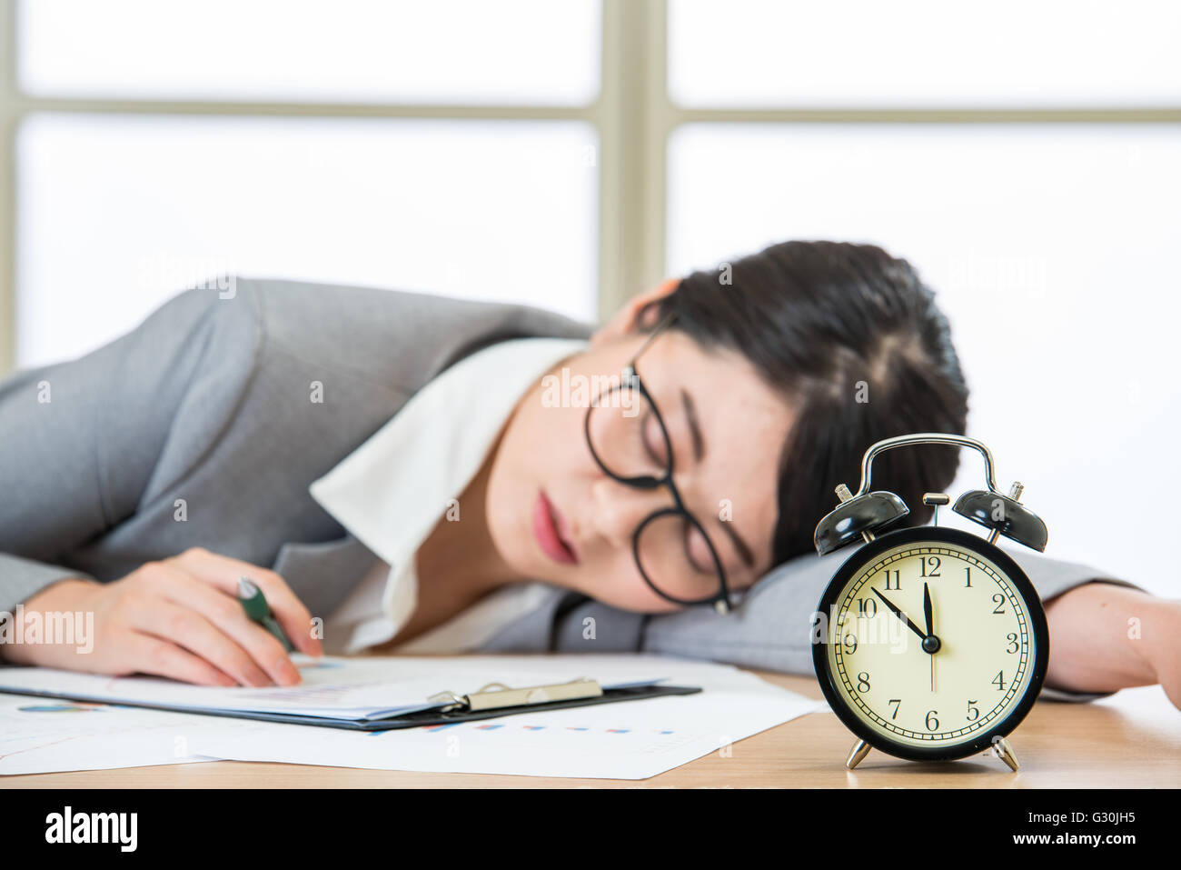 Tired woman are sleeping at desk in the office Stock Photo - Alamy